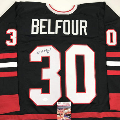 Black Chicago hockey jersey with red and white stripes, "BELFOUR" and number 30 with autograph, displaying JSA authentication sticker.