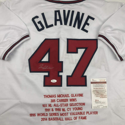 White Atlanta Braves jersey number 47 with "GLAVINE" nameplate, red numbers, career statistics printed below, and JSA authentication certificate visible on right side.