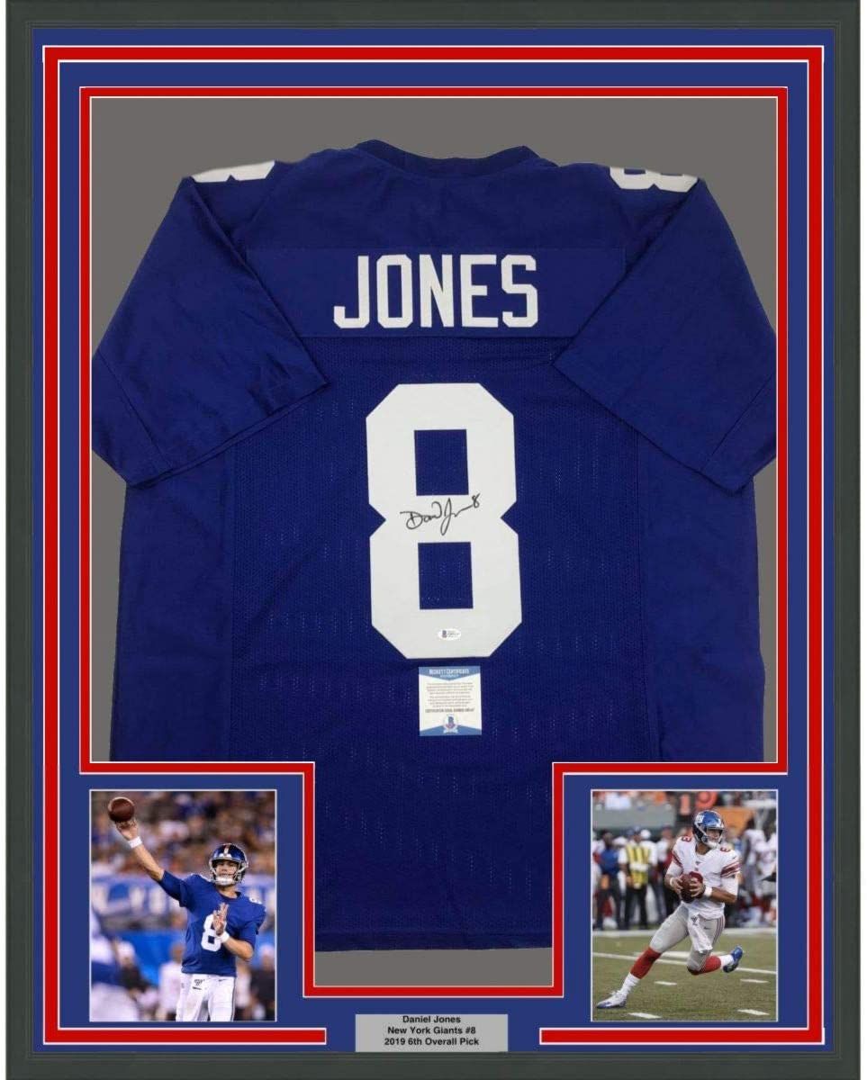 Framed blue New York Giants #8 Jones jersey with white lettering, signed, displayed with two action photos and nameplate below.