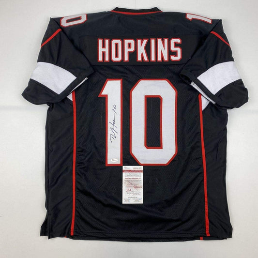 Back view of black Hopkins #10 football jersey with white and red trim, displaying autograph and JSA authentication certificate.