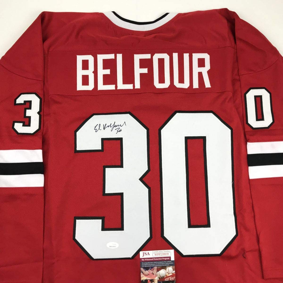 Red Chicago hockey jersey with "BELFOUR" and number 30 on back, signed in black ink, with JSA authentication label visible.