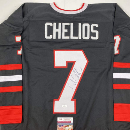Back view of signed black hockey jersey with red and white stripes, number 7, and CHELIOS nameplate, with JSA authentication label visible.