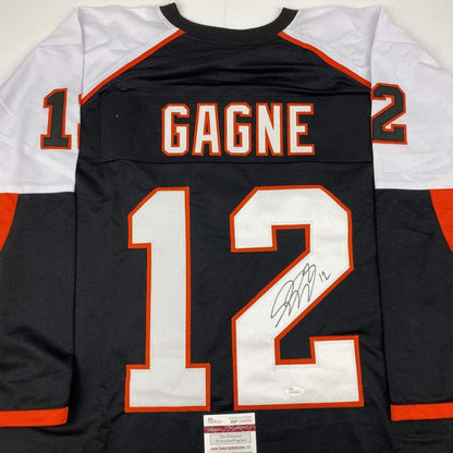 Signed black and orange Philadelphia Flyers hockey jersey number 12 with "GAGNE" nameplate, displayed flat with JSA authentication label visible at bottom.