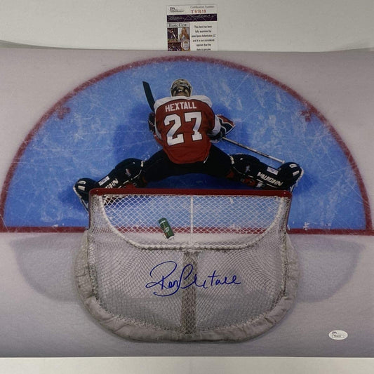 Signed photo of goaltender Ron Hextall number 27 diving into net on blue ice with red boards visible.