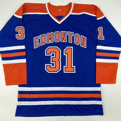 Blue Edmonton Oilers hockey jersey with orange and white stripes, displaying number 31 on chest and shoulders, laid flat against white background.