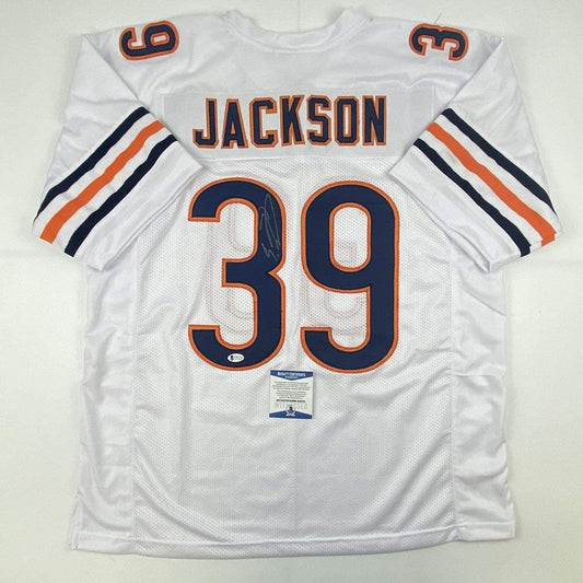 White Chicago Bears #39 Jackson football jersey laid flat, showing front with navy and orange numbering and Beckett authentication sticker.