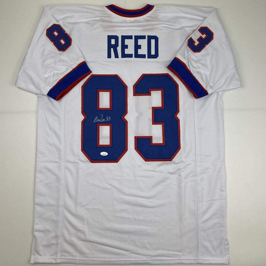 White Buffalo Bills football jersey number 83 with "REED" nameplate, displayed flat with visible autograph and authentication sticker.