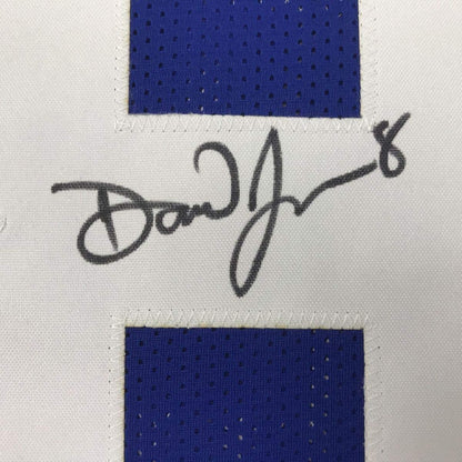 Close-up of Daniel Jones autographed signature on white matting between two blue perforated jersey fabric swatches.