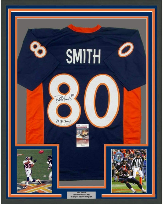 Framed navy and orange Denver Broncos jersey number 80 signed by Rod Smith with Super Bowl patches and two action photos.