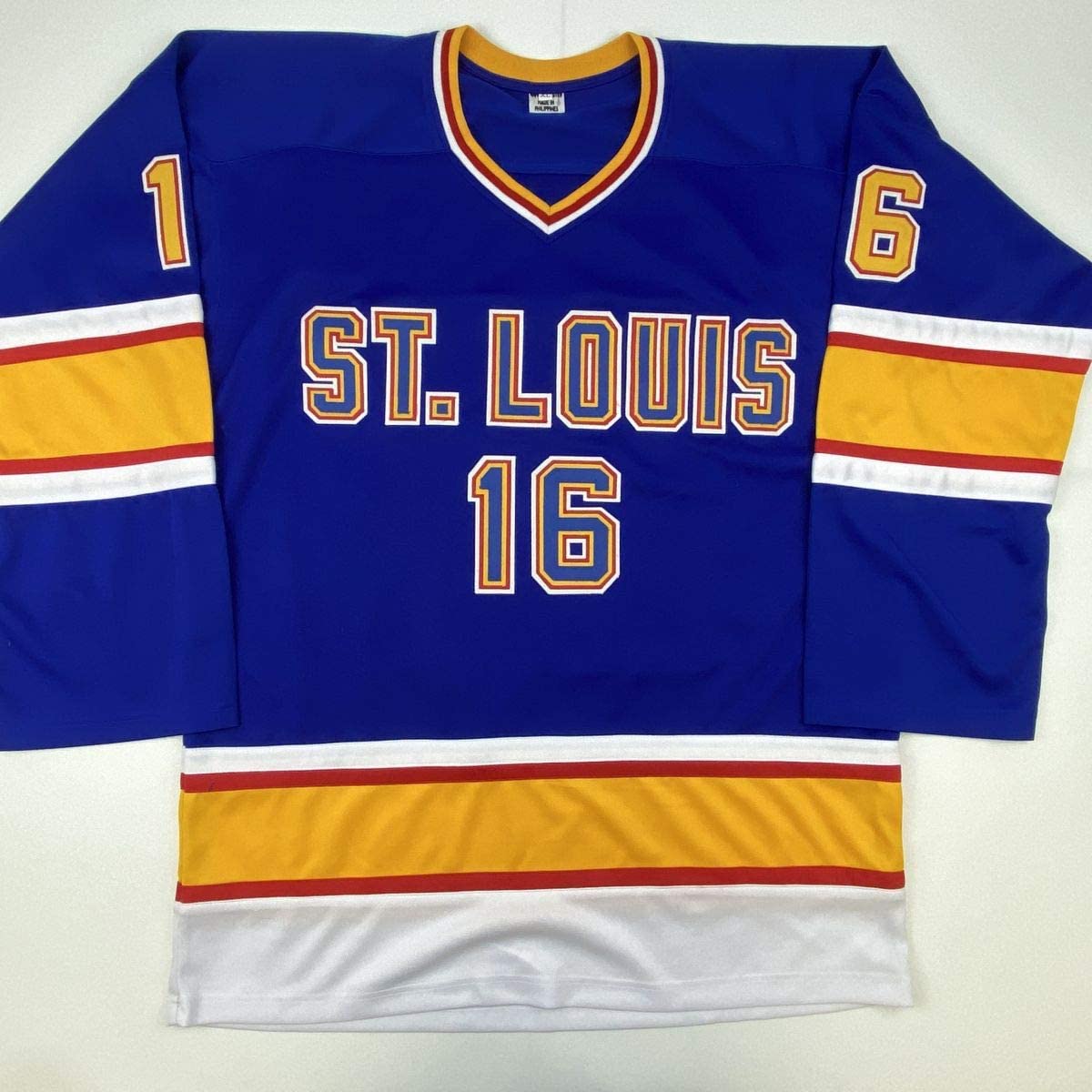 Blue St. Louis hockey jersey with gold and white stripes, displaying number 16 on front and sleeves.