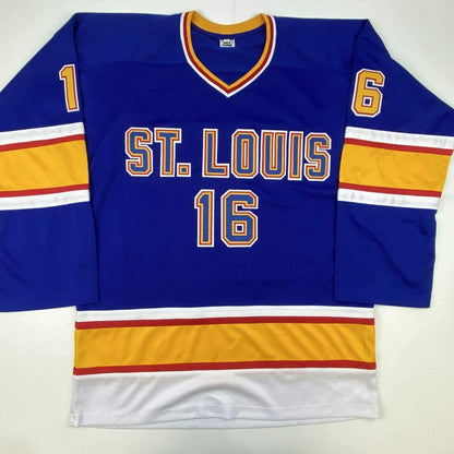 Blue St. Louis hockey jersey with gold and white stripes, displaying number 16 on front and sleeves.