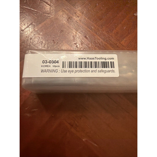 Product label on plastic packaging showing part number 03-0304, barcode, "KOREA 10pcs," website URL, and safety warning text on brown textured background.