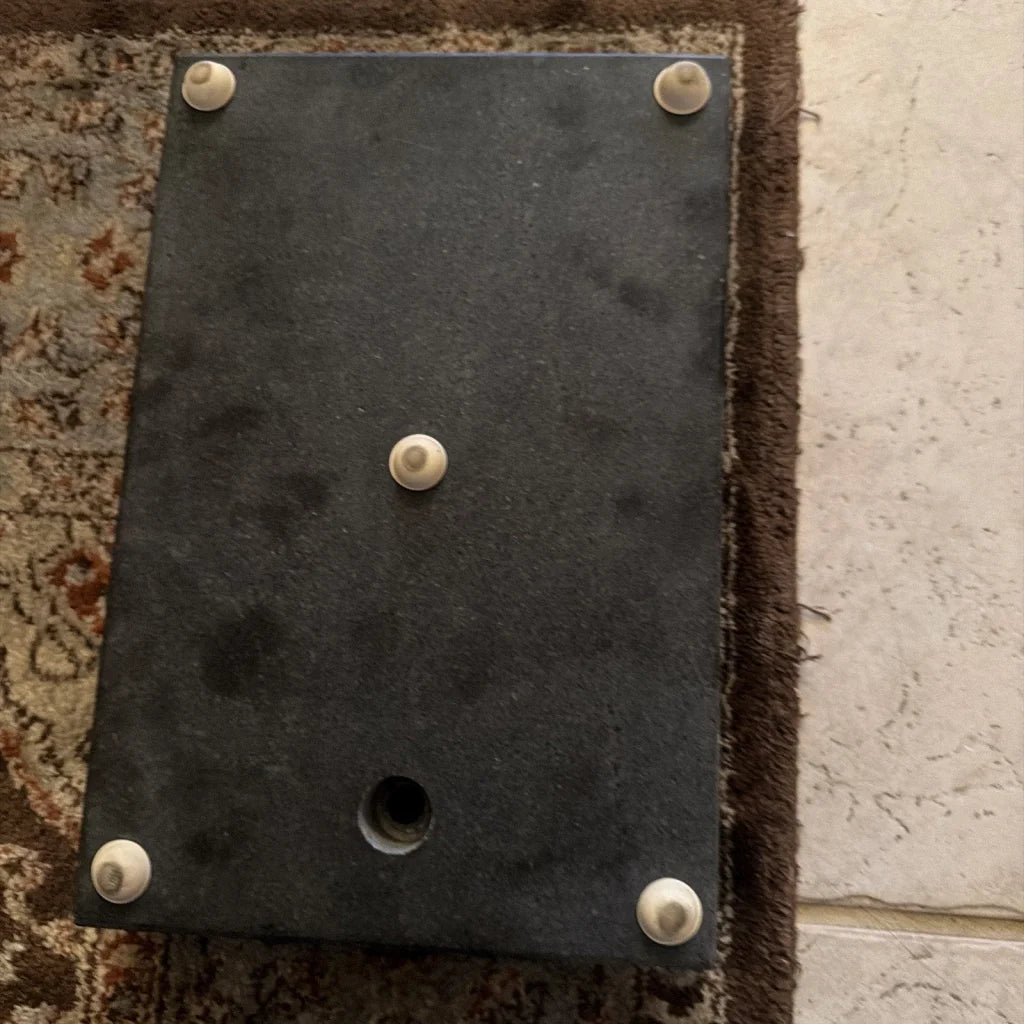 Back of 8 x 12 x 2 inch granite surface plate with black metal plate and screws