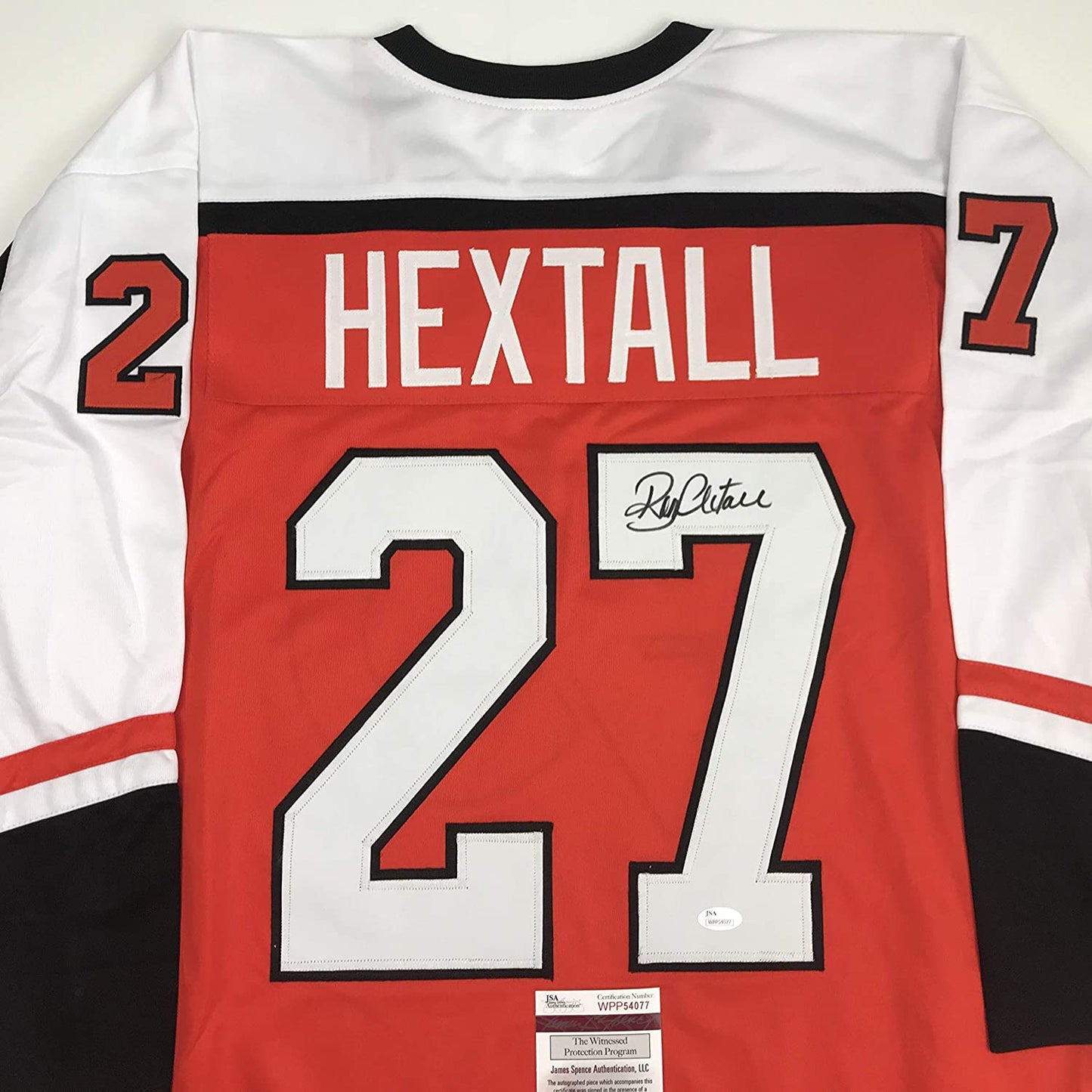 Back view of red Philadelphia Flyers hockey jersey with "HEXTALL" nameplate, number 27, and autographed signature with JSA authentication certificate visible.