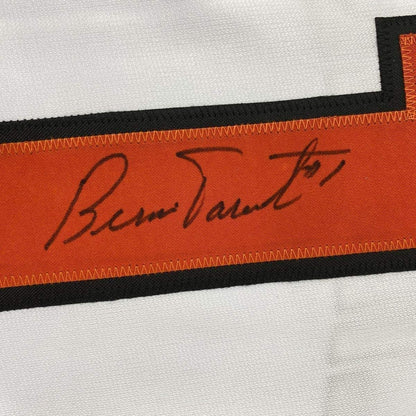 Close-up of Bernie Parent's handwritten signature in black ink on orange fabric strip with black borders.