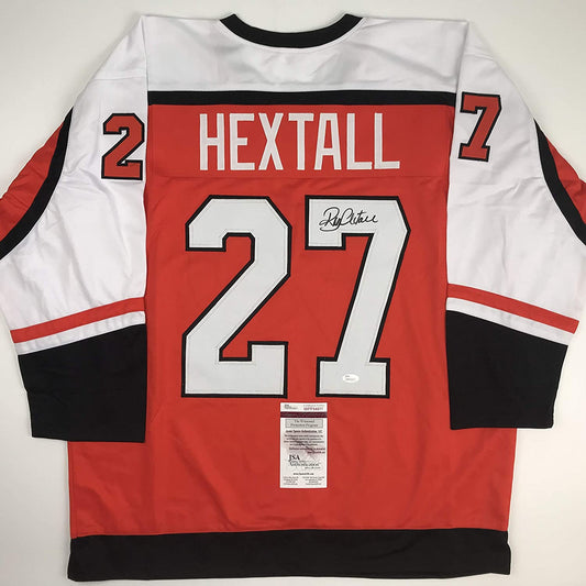 Back view of signed red, white, and black hockey jersey displaying "HEXTALL 27" with JSA authentication certificate attached.