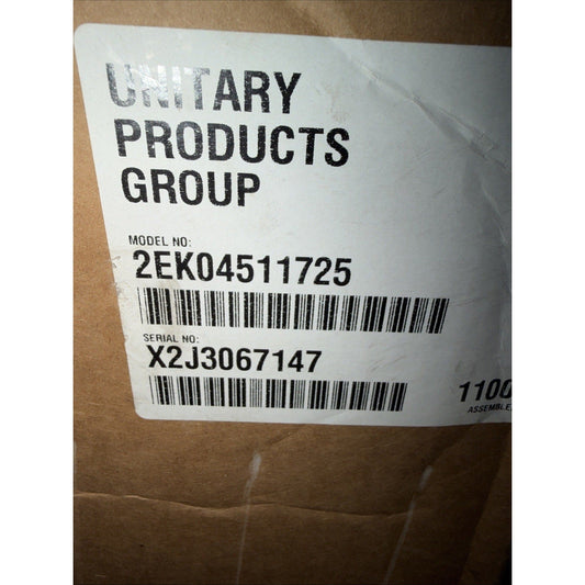 White label on brown cardboard box showing "Unitary Products Group" text, model number 2EK04511725, serial number X2J3067147, and barcodes.