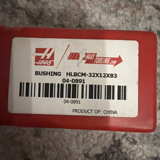 Red plastic package with white label showing Haas Tooling logo, part number HLBCM-32X12X83, barcode, and "Product of China" text.