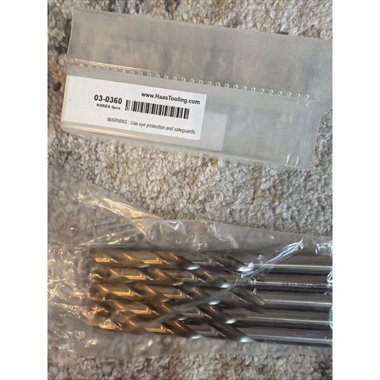 Sealed plastic package containing five gold and black coated drill bits with label showing website www.HaasTooling.com and product number 03-0360.