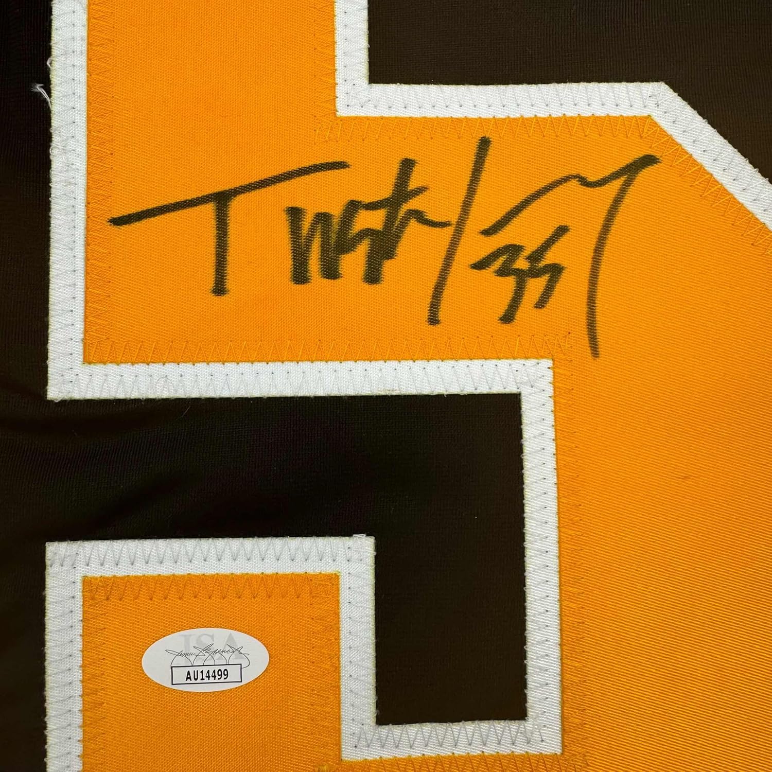 Close-up of handwritten signature on orange and black hockey jersey with white trim and JSA authentication sticker.