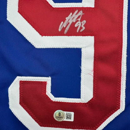 Close-up of signed red and blue New York Rangers hockey jersey number 93 with Beckett authentication hologram visible at bottom.