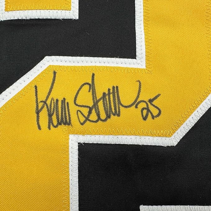 Close-up of autographed yellow and black hockey jersey showing handwritten signature "Kevin Stevens" with number 25.