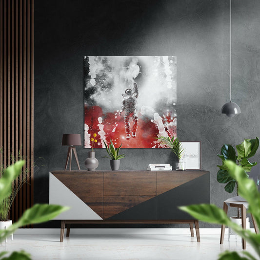 Modern living room displaying astronaut wall art in grayscale and red tones above wooden sideboard with decor.