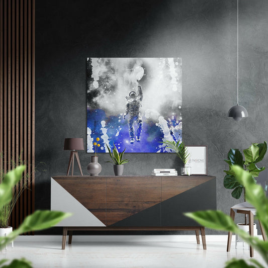 Modern room interior featuring astronaut artwork with white smoke and blue cosmic elements displayed above wooden credenza with plants and decor.