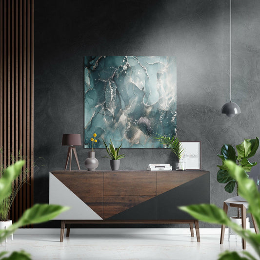 Teal and silver marble abstract wall art displayed above a wooden credenza in a modern interior setting with plants and pendant lighting.