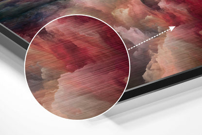 Close-up detail of brushed aluminum Dibond wall art showing red and pink cloud textures with circular magnification overlay and directional arrow.