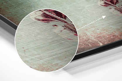 Close-up magnified detail of brushed aluminium surface showing wood grain texture with red paint streaks and splatters.