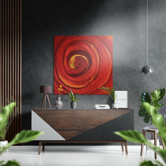 Red spiral abstract wall art with gold center tones displayed above mid-century modern wooden dresser in contemporary interior.