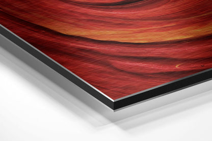 Close-up angled view of red brushed aluminum Dibond wall art showing layered edge construction with black and gray borders.