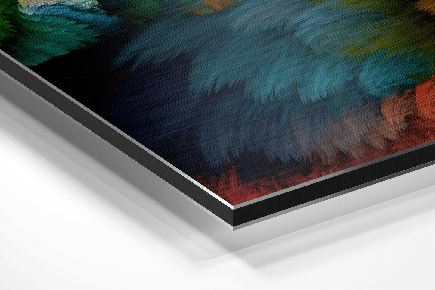 Angled close-up of layered aluminium dibond wall art showing textured surface with teal, dark blue, and coral brushed finishes.