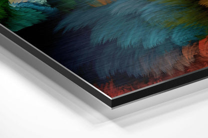 Angled close-up of layered aluminium dibond wall art showing textured surface with teal, dark blue, and coral brushed finishes.