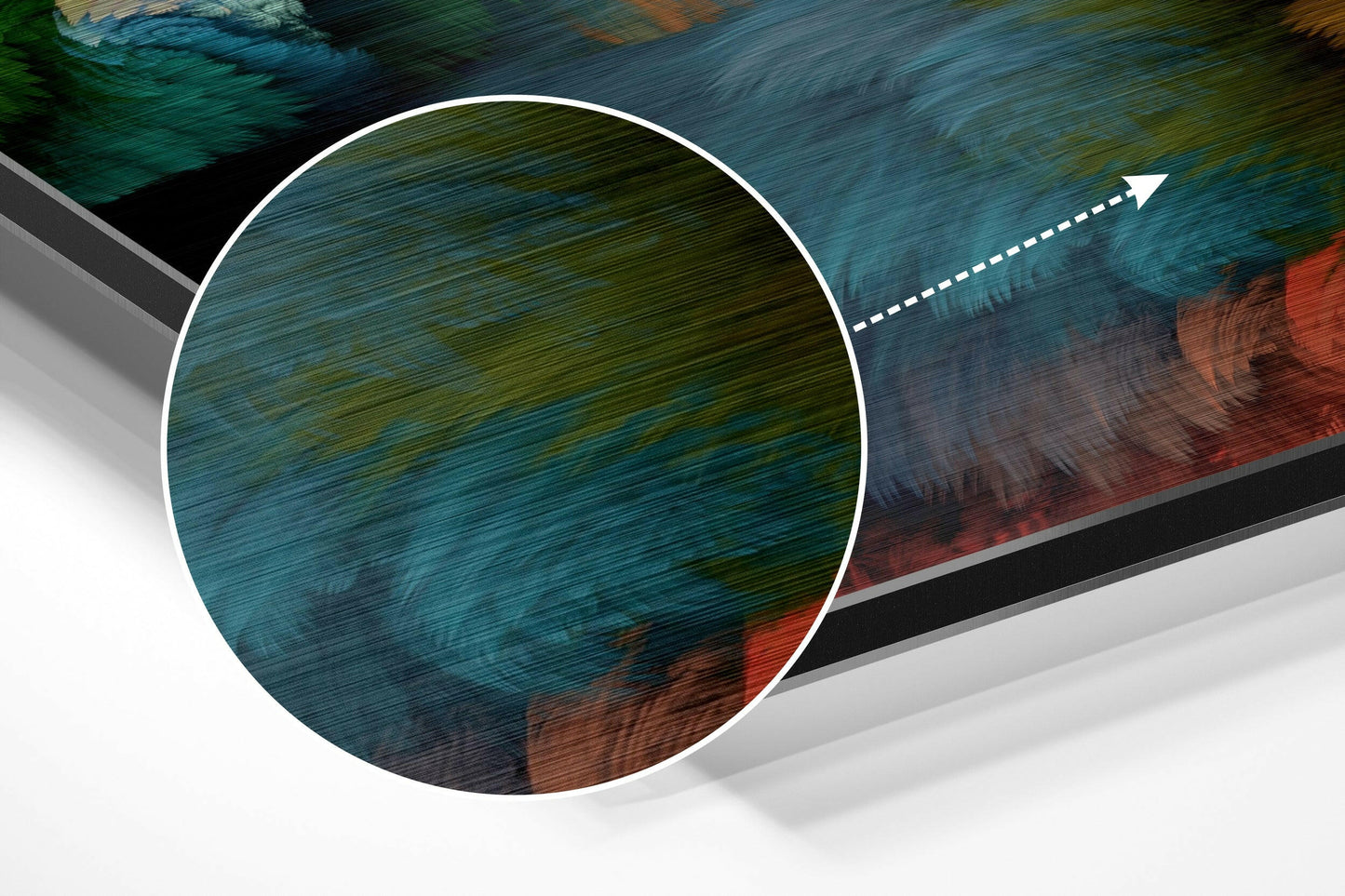 Close-up angled view of circular brushed aluminum Dibond panel showing teal, green, and rust-red variegated surface with directional arrow overlay.