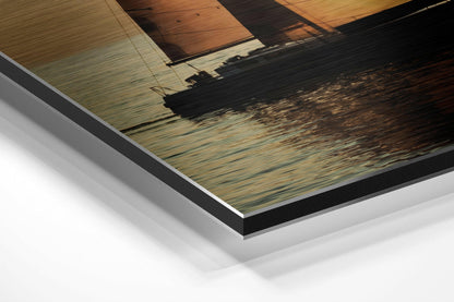 Angled close-up of brushed aluminium Dibond print showing layered edges with sailboat at sunset reflected on calm water.