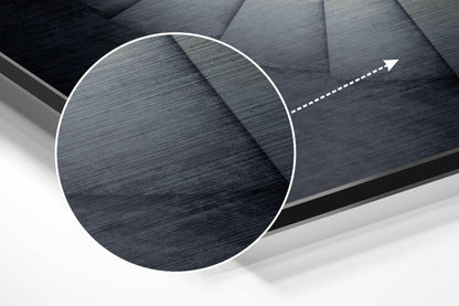 Close-up detail of brushed aluminum Dibond wall art showing textured surface with circular magnified section and directional arrow indicator.