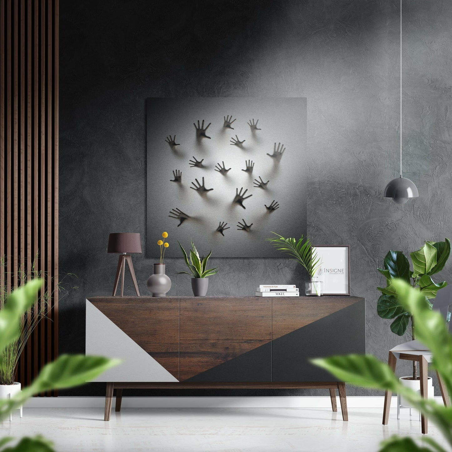 Brushed aluminum wall art featuring multiple raised hand silhouettes displayed above a wooden dresser in a modern interior setting.