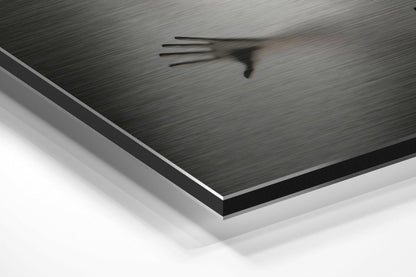 Close-up angled view of brushed aluminum Dibond panel showing layered edge construction with black and white layers beneath dark gray textured surface.