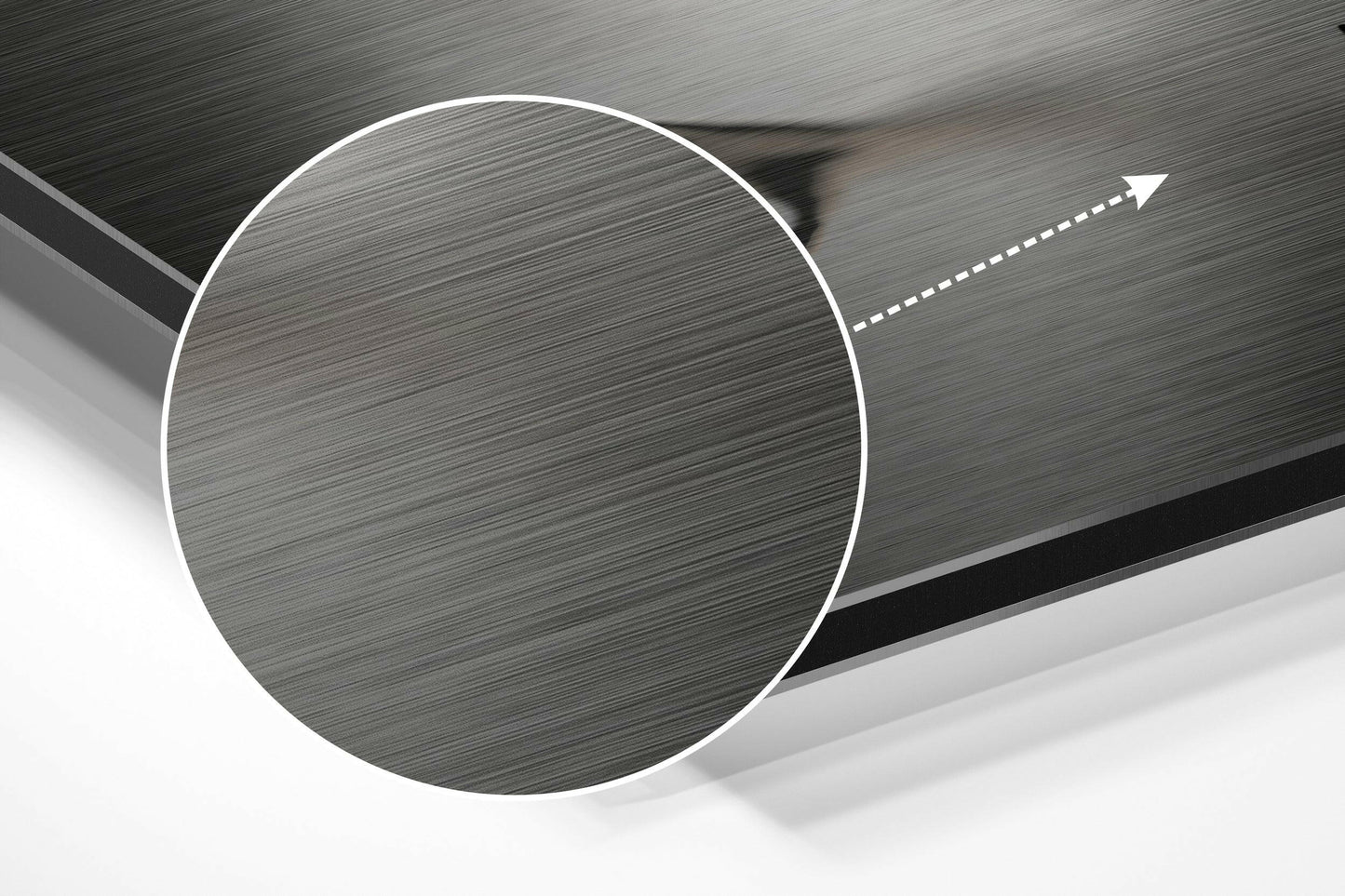 Close-up angled view of brushed aluminum Dibond sheet showing circular cutout detail with directional arrow on textured metallic surface.