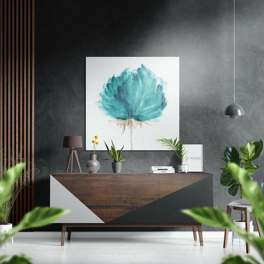 Teal watercolor flower art displayed on dark textured wall above wooden mid-century sideboard with styling accessories.
