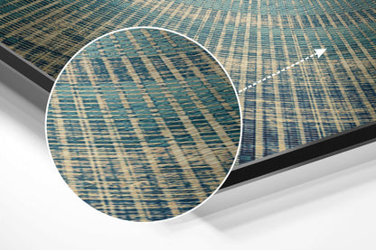 Close-up detail of brushed aluminum Dibond wall art showing teal and cream woven texture pattern with magnified circular view.
