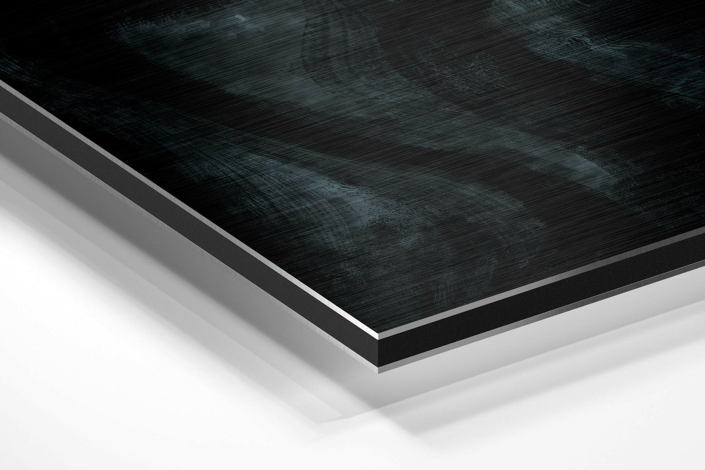 Close-up angled view of layered Dibond wall art with brushed black aluminum top surface and white backing layers.