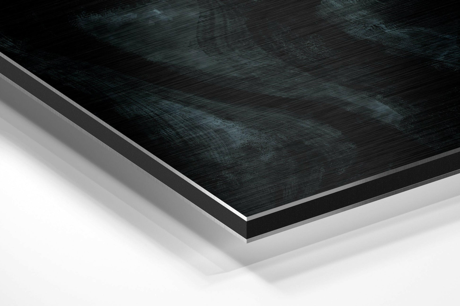 Close-up angled view of layered Dibond wall art with brushed black aluminum top surface and white backing layers.