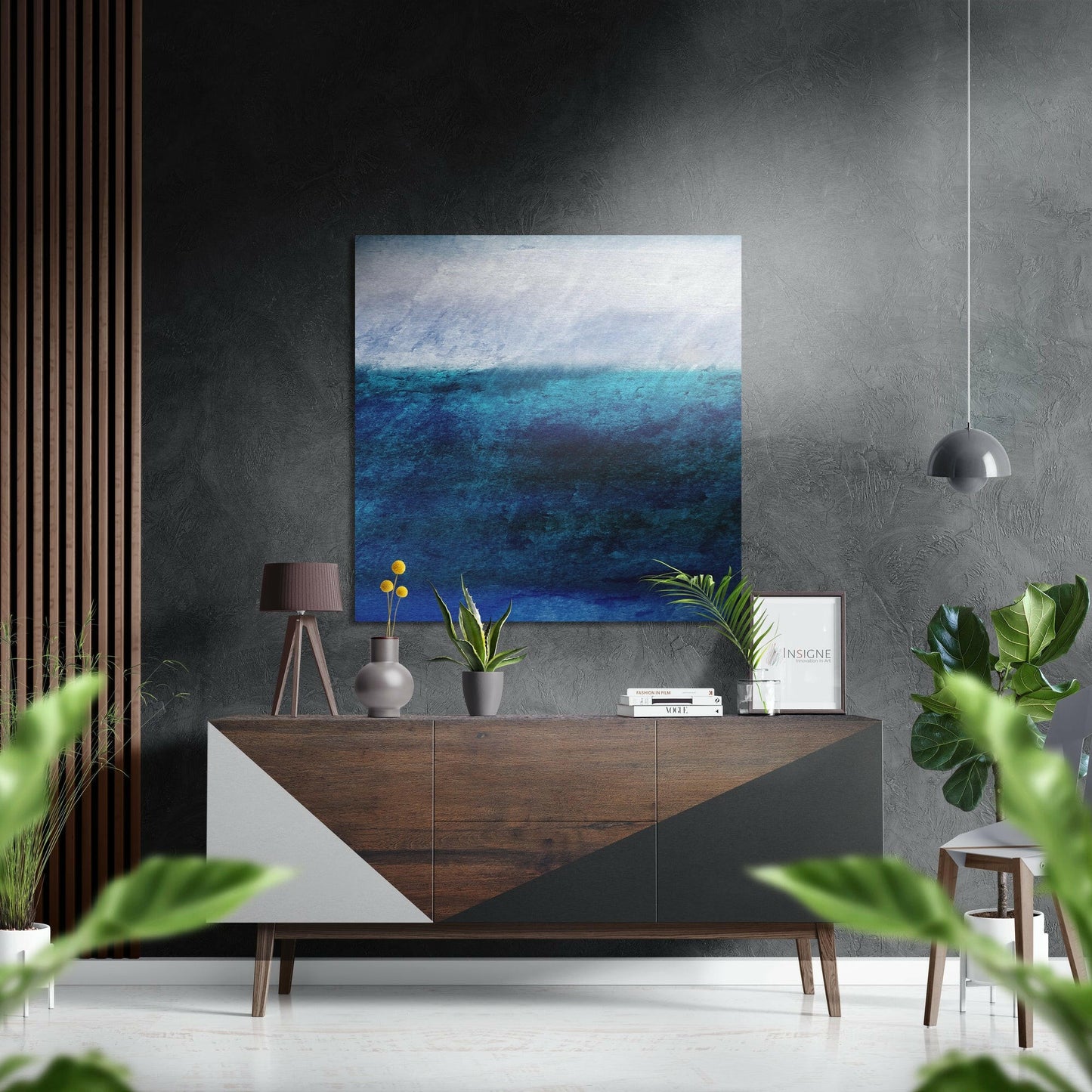 Blue Cascades Brushed Aluminium Dibond Wall Art displayed above a wooden dresser in a modern interior with grey walls and green plants.