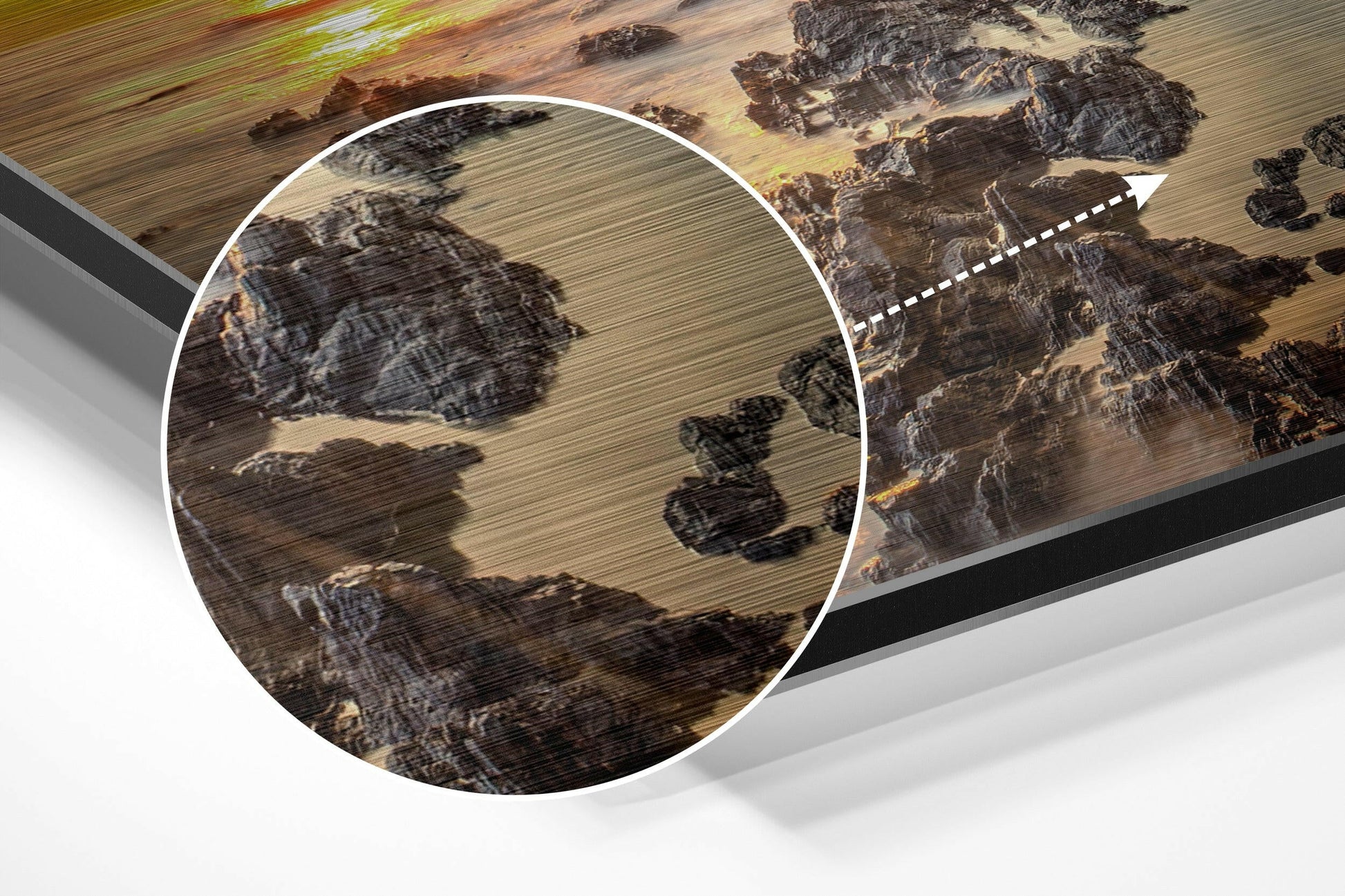 Close-up detail of brushed aluminium Dibond wall art showing aerial landscape with fields, rocks, and trees in earth tones, with magnified circular inset highlighting texture.