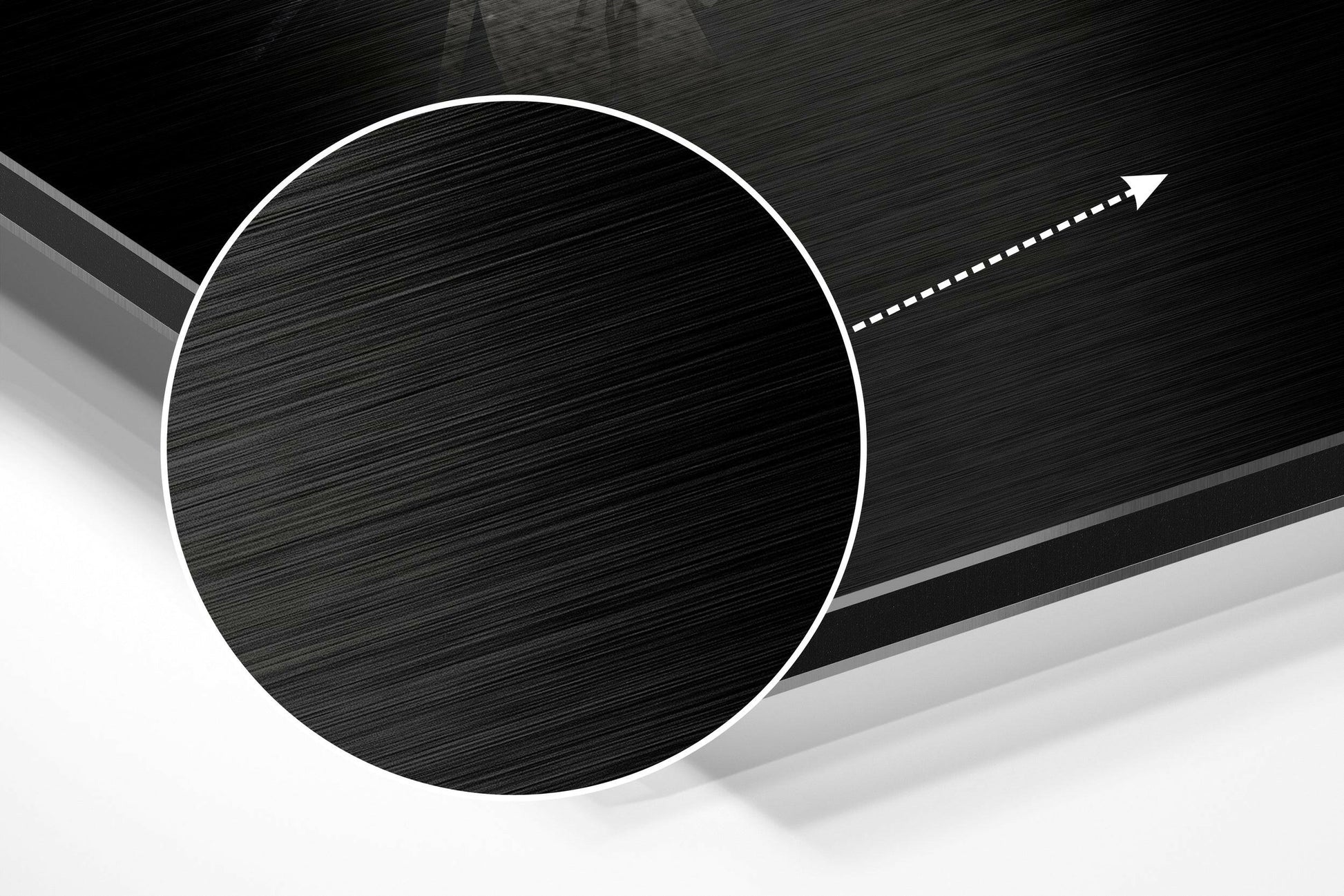 Close-up angled view of brushed aluminum Dibond wall art featuring a large black circle with white outline and directional arrow on textured background.