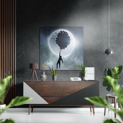 Surreal artwork featuring silhouetted figure holding balloons against glowing moon in starry night sky, displayed above wooden dresser in modern interior.