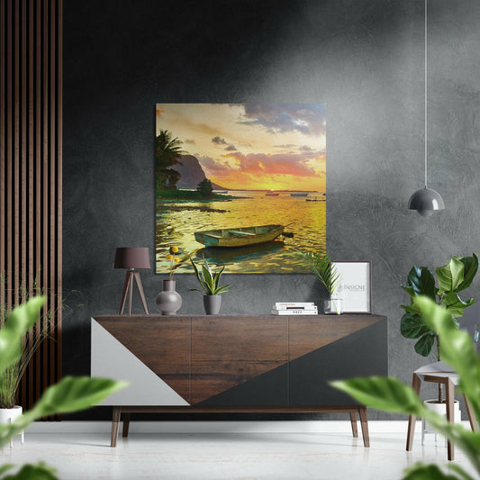 Modern interior setting displaying tropical sunset artwork above wood and white dresser with plants and decor.